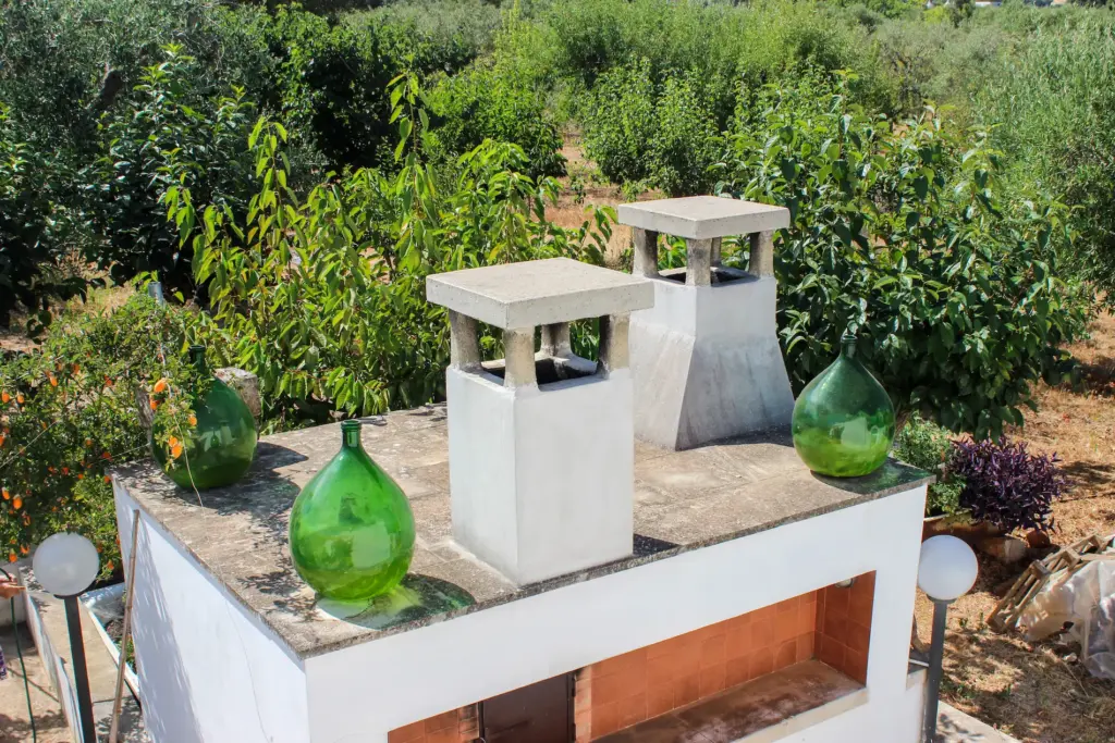 Outdoor terrace of Borgo Tortorella Masseria surrounded by olive trees in the Apulian countryside